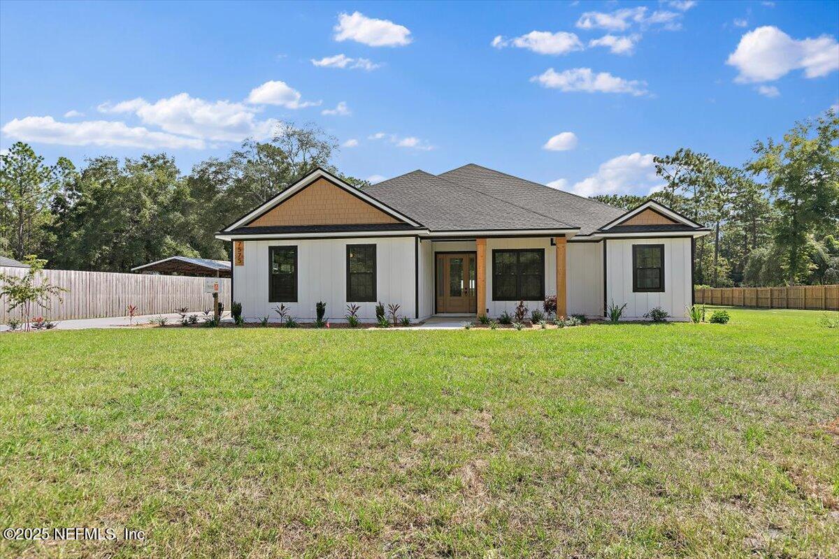 a front view of a house with yard and green space