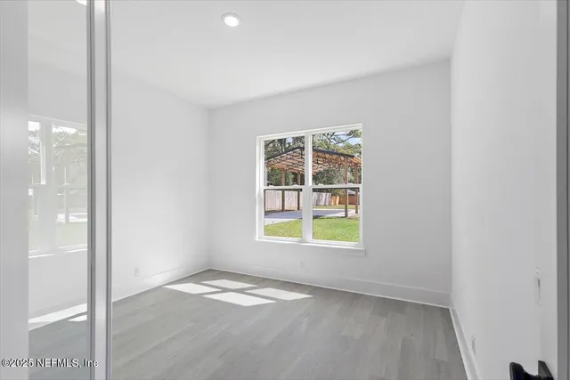 an empty room with a empty space and windows