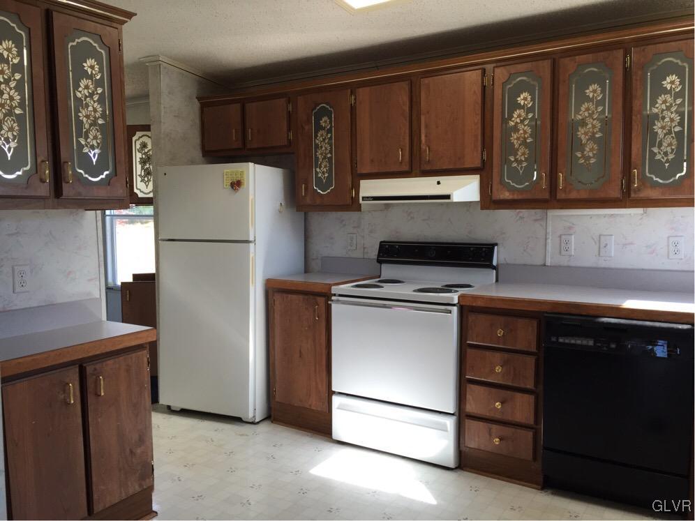 468 North Penn Dixie Road Bath, PA 18014 - Photo 5 of 14 a kitchen with stainless steel appliances granite countertop a refrigerator sink and cabinets