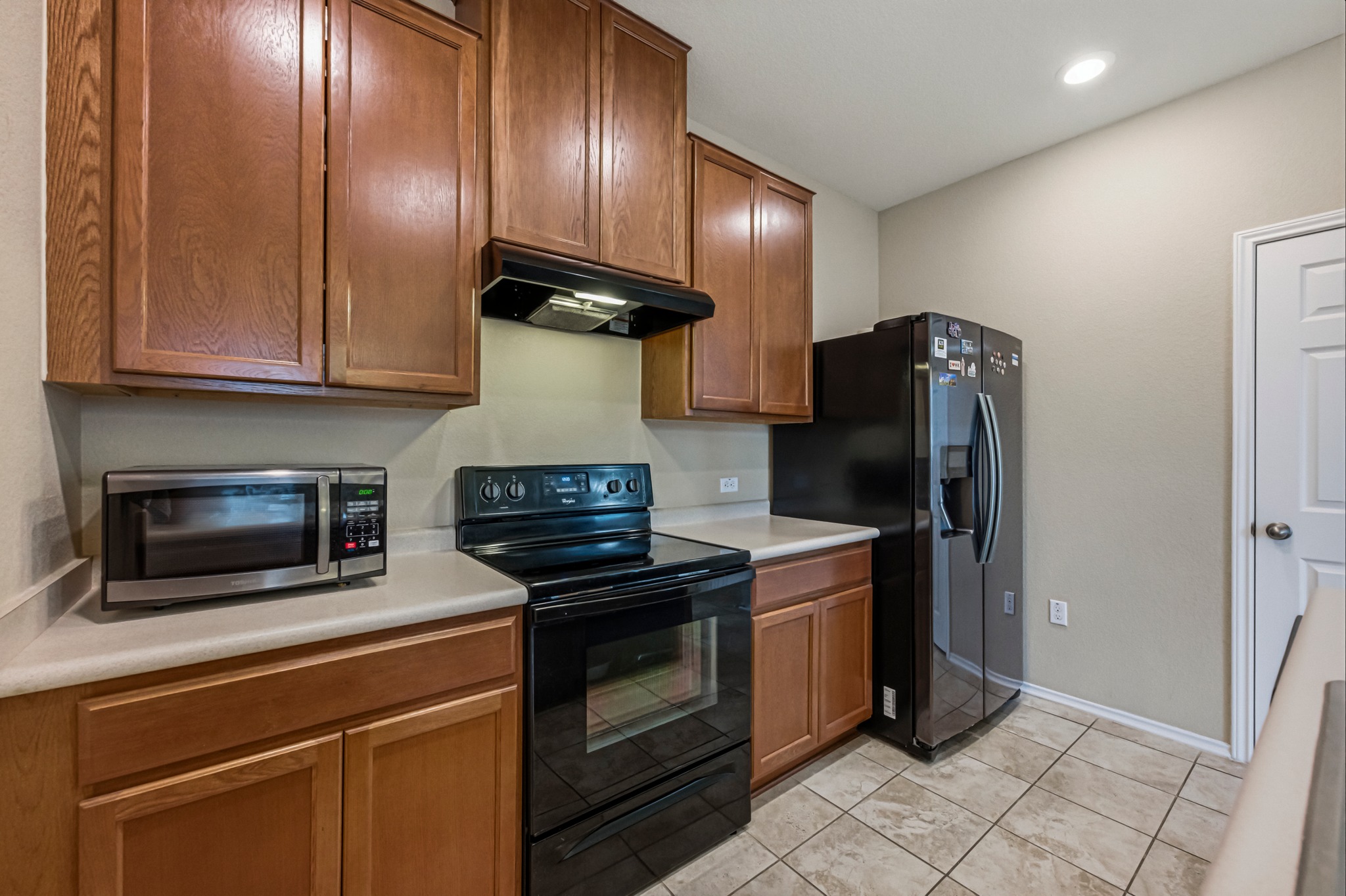 14620 Goshawk Drive Pflugerville, TX 78660 - Photo 11 of 24 a kitchen with stainless steel appliances granite countertop a refrigerator stove and sink