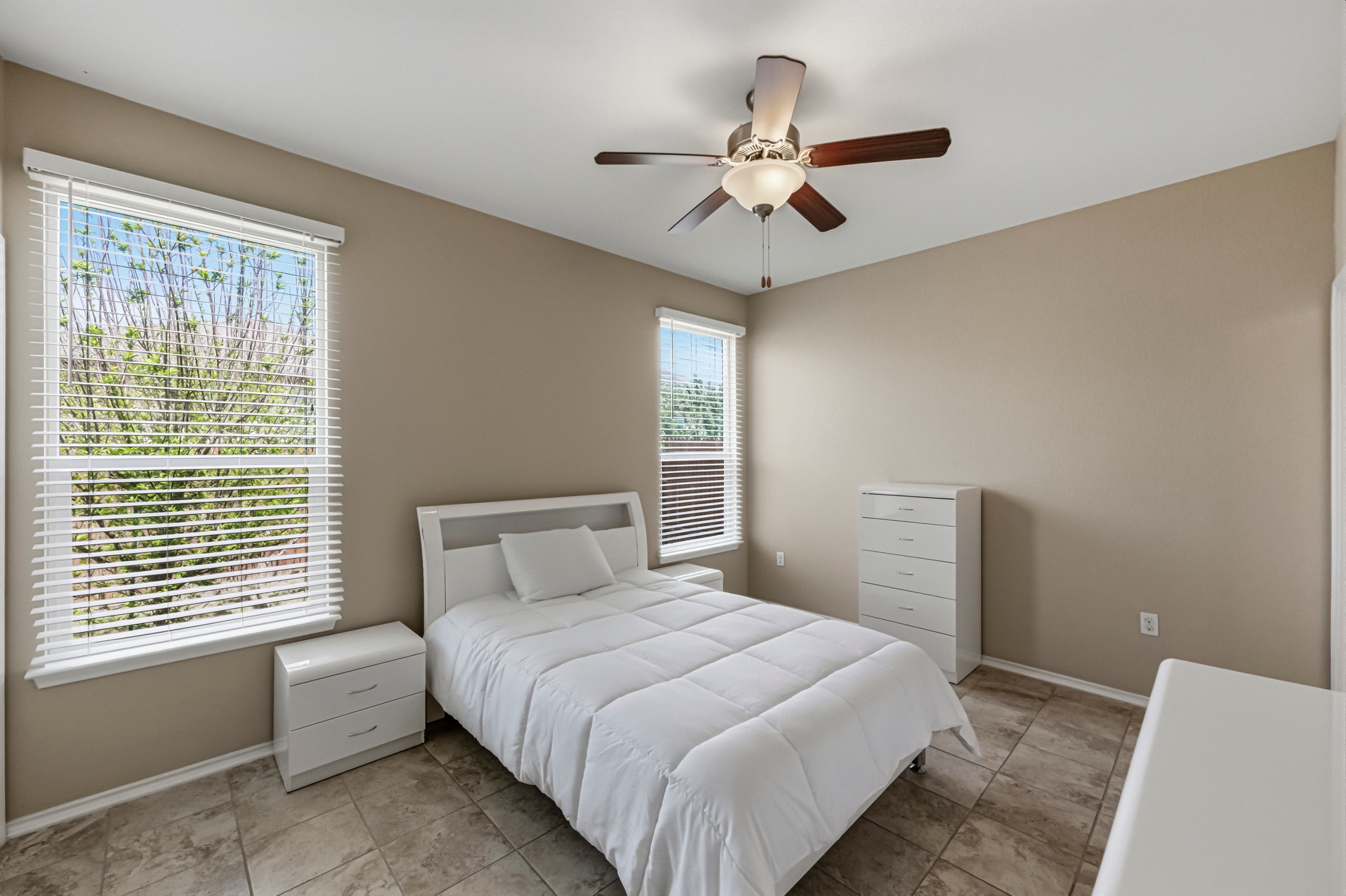 14620 Goshawk Drive Pflugerville, TX 78660 - Photo 12 of 24 a bedroom with a large bed and a window