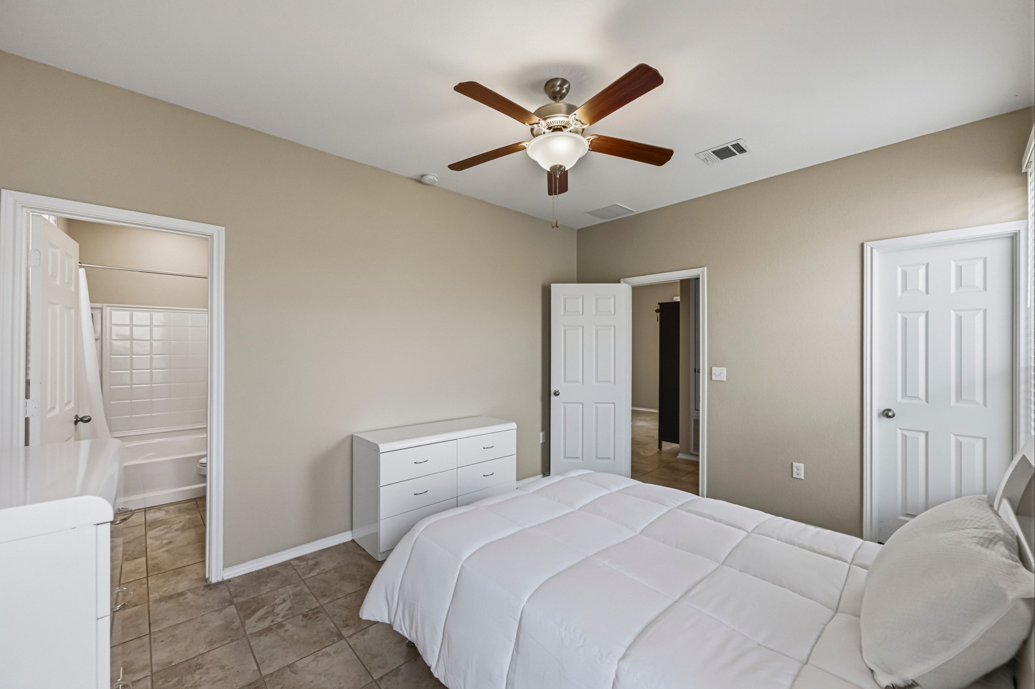 14620 Goshawk Drive Pflugerville, TX 78660 - Photo 13 of 24 a bedroom with a large bed and a chandelier