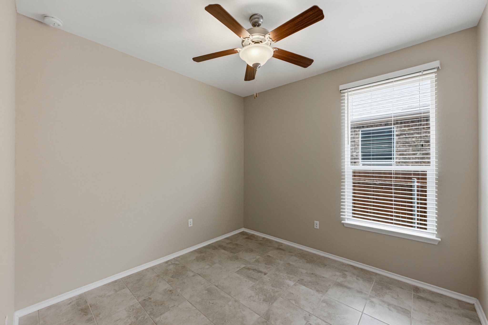 14620 Goshawk Drive Pflugerville, TX 78660 - Photo 18 of 24 an empty room with a window and a ceiling fan