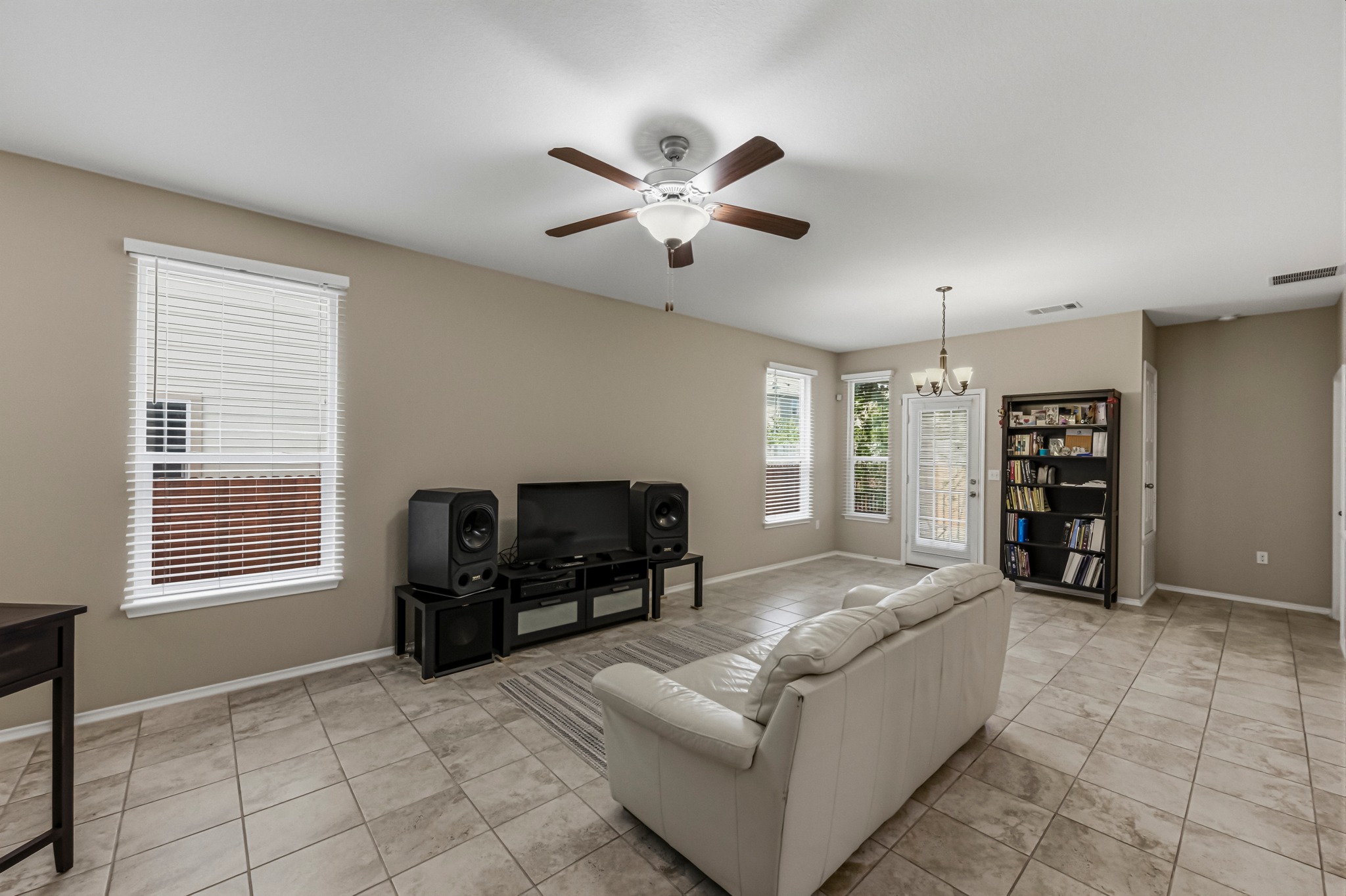 14620 Goshawk Drive Pflugerville, TX 78660 - Photo 3 of 24 a living room with furniture and a flat screen tv