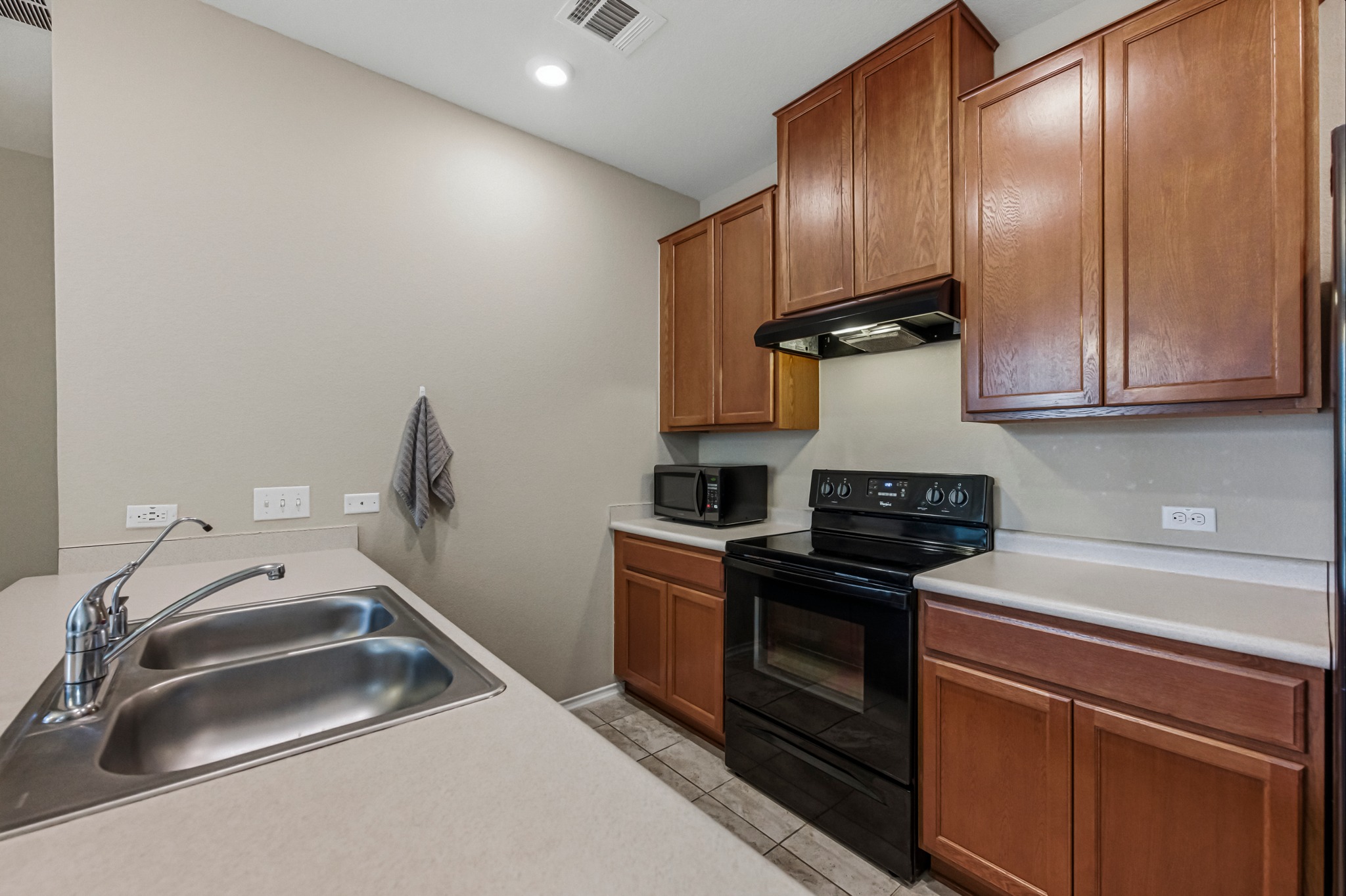 14620 Goshawk Drive Pflugerville, TX 78660 - Photo 8 of 24 a kitchen with granite countertop a sink stainless steel appliances and cabinets