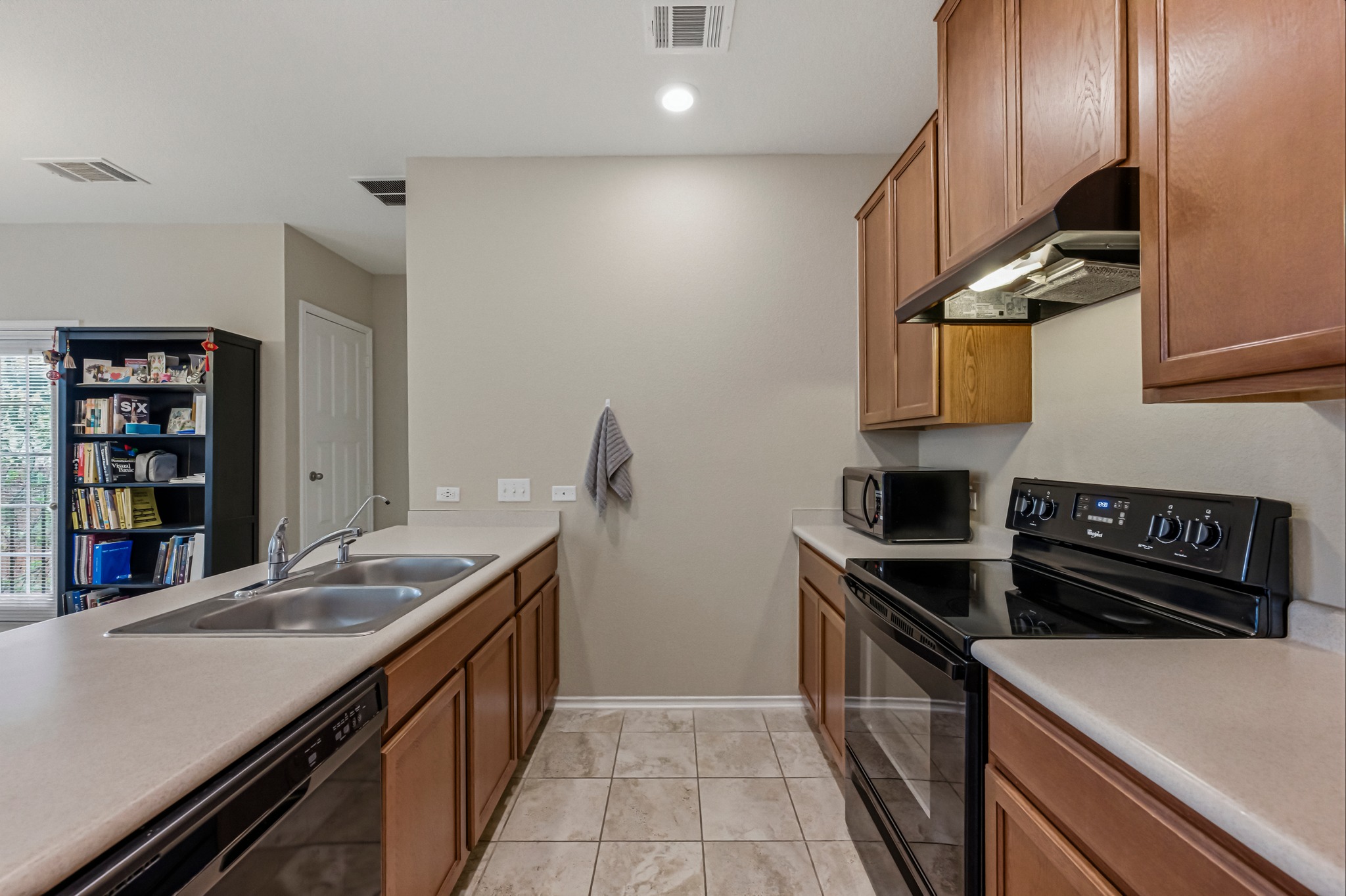 14620 Goshawk Drive Pflugerville, TX 78660 - Photo 9 of 24 a kitchen with stainless steel appliances granite countertop a sink and stove