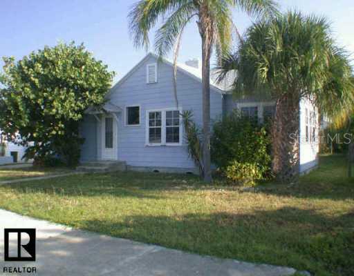 14041 Miramar Avenue Madeira Beach, FL 33708 - Photo 1 of 1 a view of a yard with a house in the background