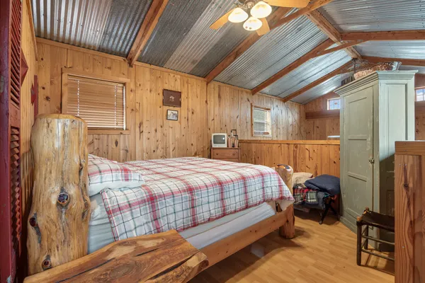 a bedroom with a bed next to a window