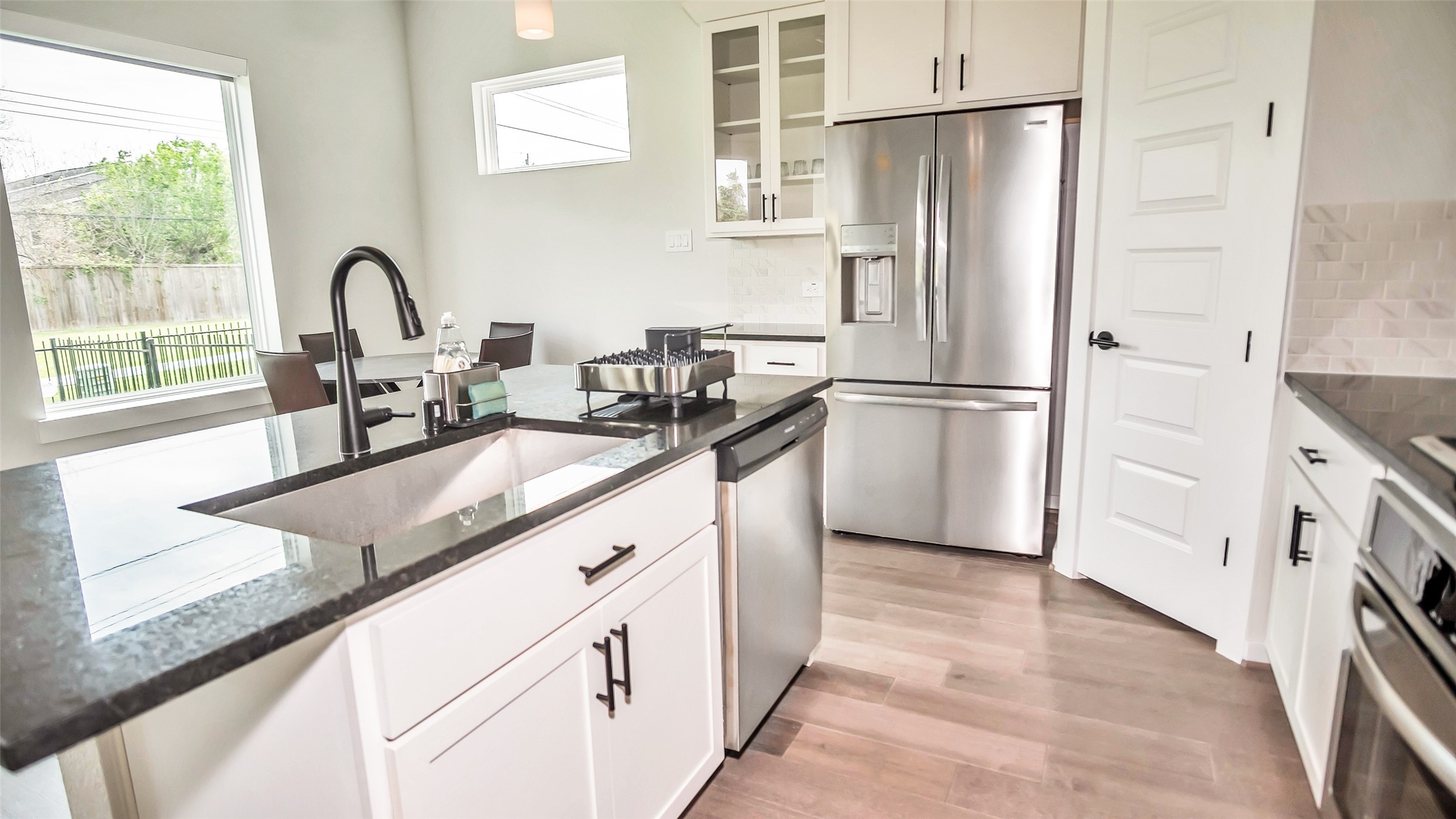1919 Pueblo Nuevo Path Houston, TX 77077 - Photo 49 of 50 a kitchen with granite countertop a refrigerator and a sink