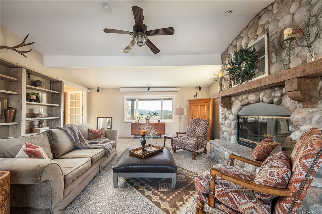 14956 Fruitvale Road Valley Center, CA 92082 - Photo 5 of 25 Beautiful custom stone fireplace adds warmth to Living Room.