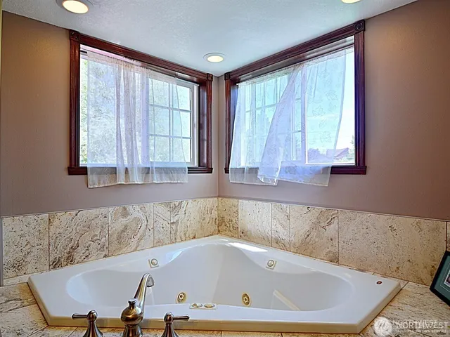 a bath tub sitting in a bathroom next to a window