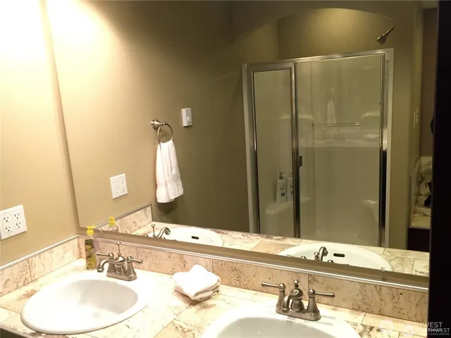 a bathroom with a granite countertop sink and a mirror