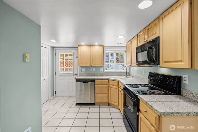 a kitchen with a sink stove and cabinets