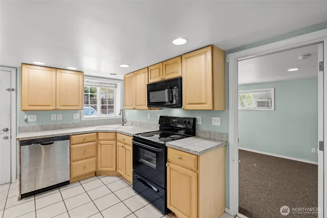 a kitchen with granite countertop cabinets stainless steel appliances and a counter space