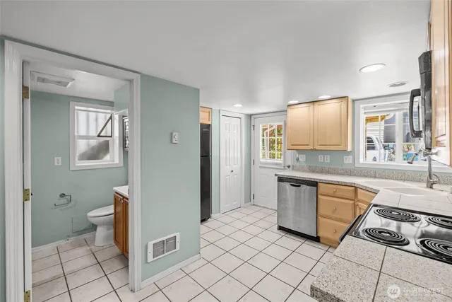 a large bathroom with a granite countertop sink and a mirror