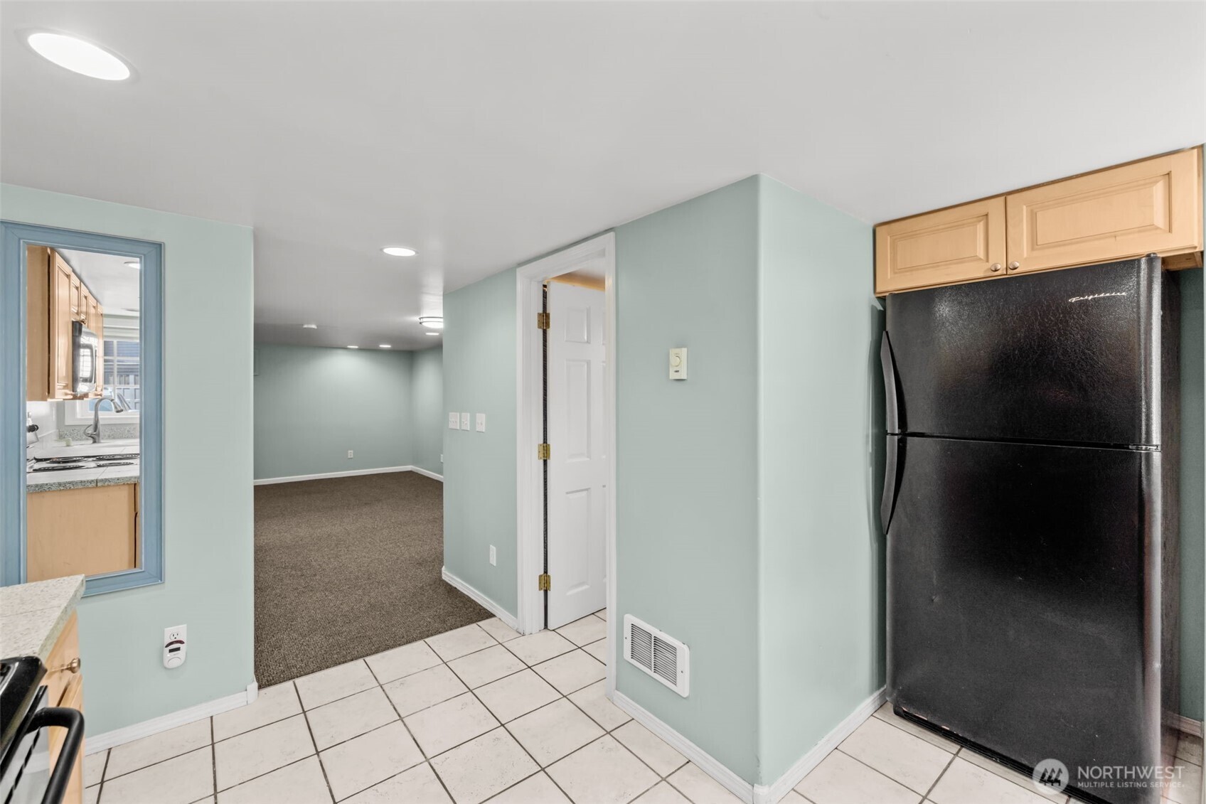 7842 Lake City Way Northeast Seattle, WA 98115 - Photo 24 of 36 a view of a refrigerator in kitchen and an empty room