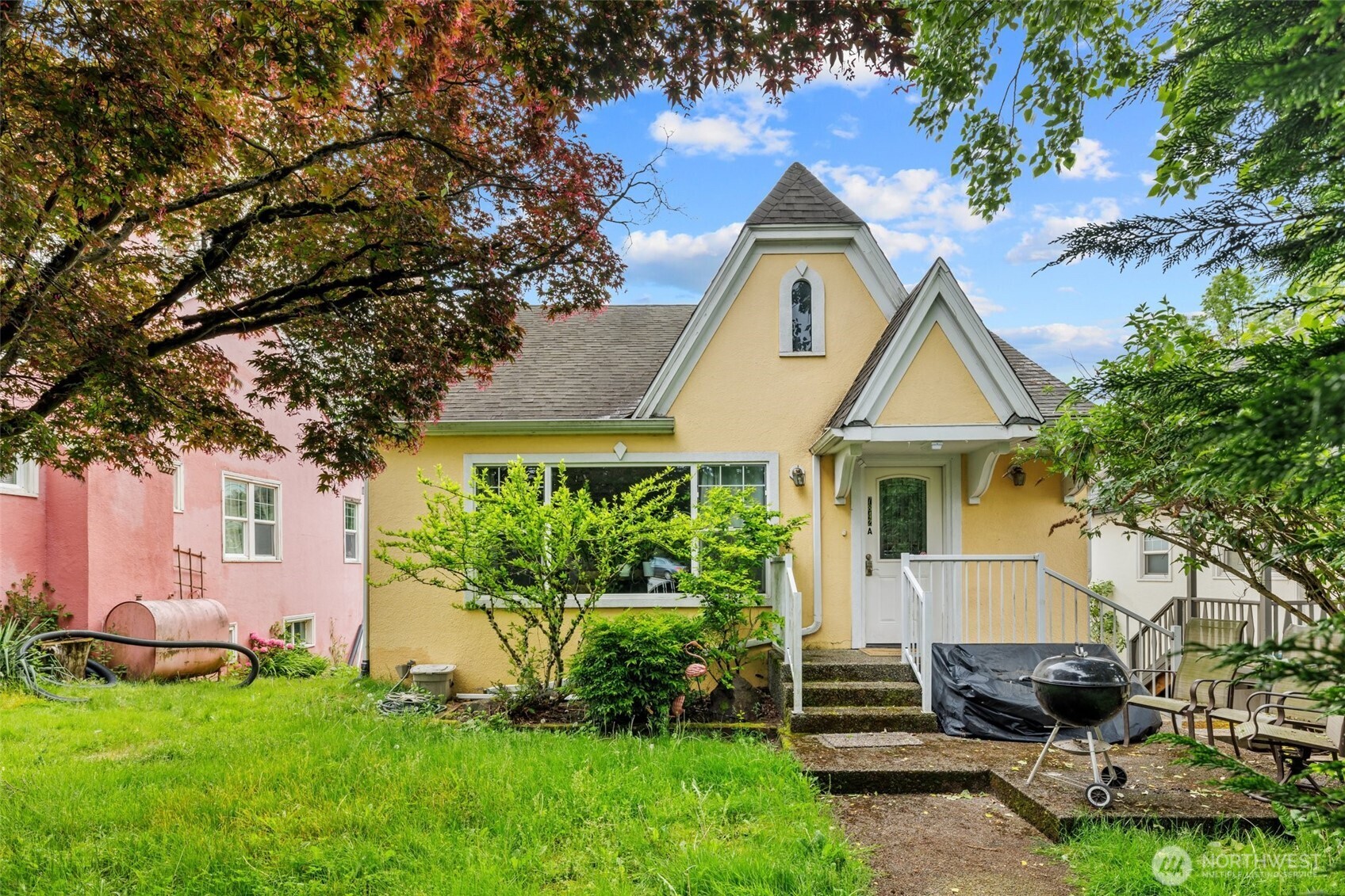7842 Lake City Way Northeast Seattle, WA 98115 - Photo 34 of 36 a front view of a house with a yard