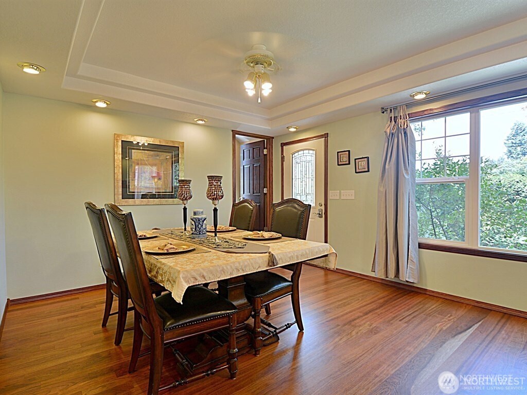 7842 Lake City Way Northeast Seattle, WA 98115 - Photo 9 of 36 a view of a dining room with furniture window and wooden floor