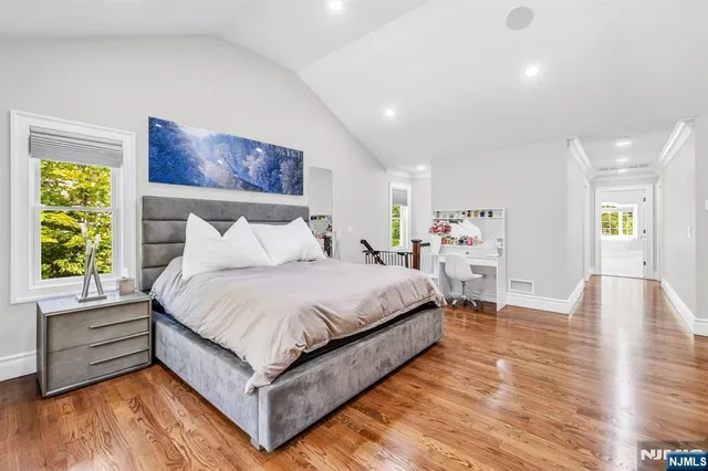 a bedroom with a bed and a painting on the wall