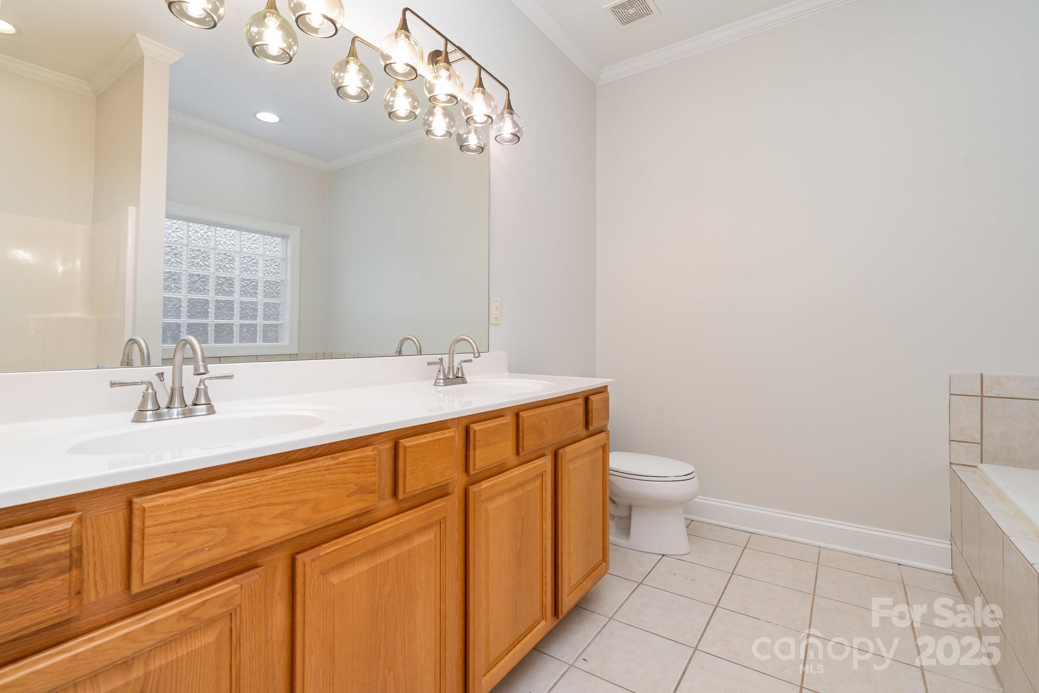 2615 Rolling Ridge Drive Hickory, NC 28602 - Photo 16 of 29 a bathroom with a double vanity sink a toilet and a mirror