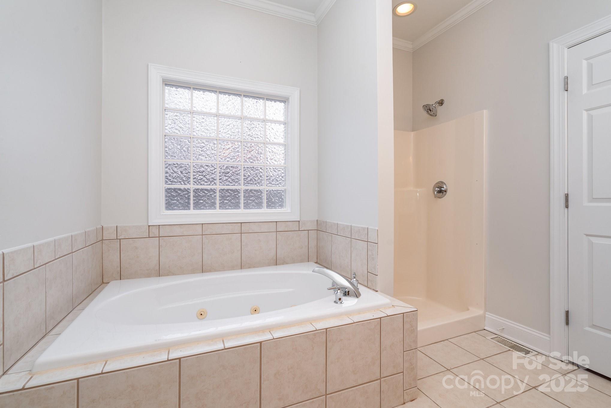 2615 Rolling Ridge Drive Hickory, NC 28602 - Photo 17 of 29 a white bath tub sitting in a bathroom next to a window