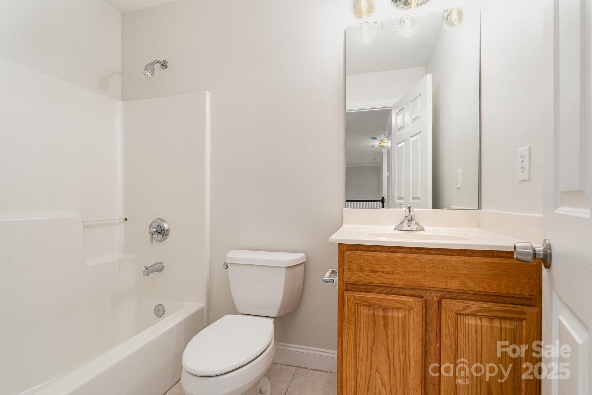 2615 Rolling Ridge Drive Hickory, NC 28602 - Photo 21 of 29 a bathroom with a granite countertop toilet a sink and a mirror