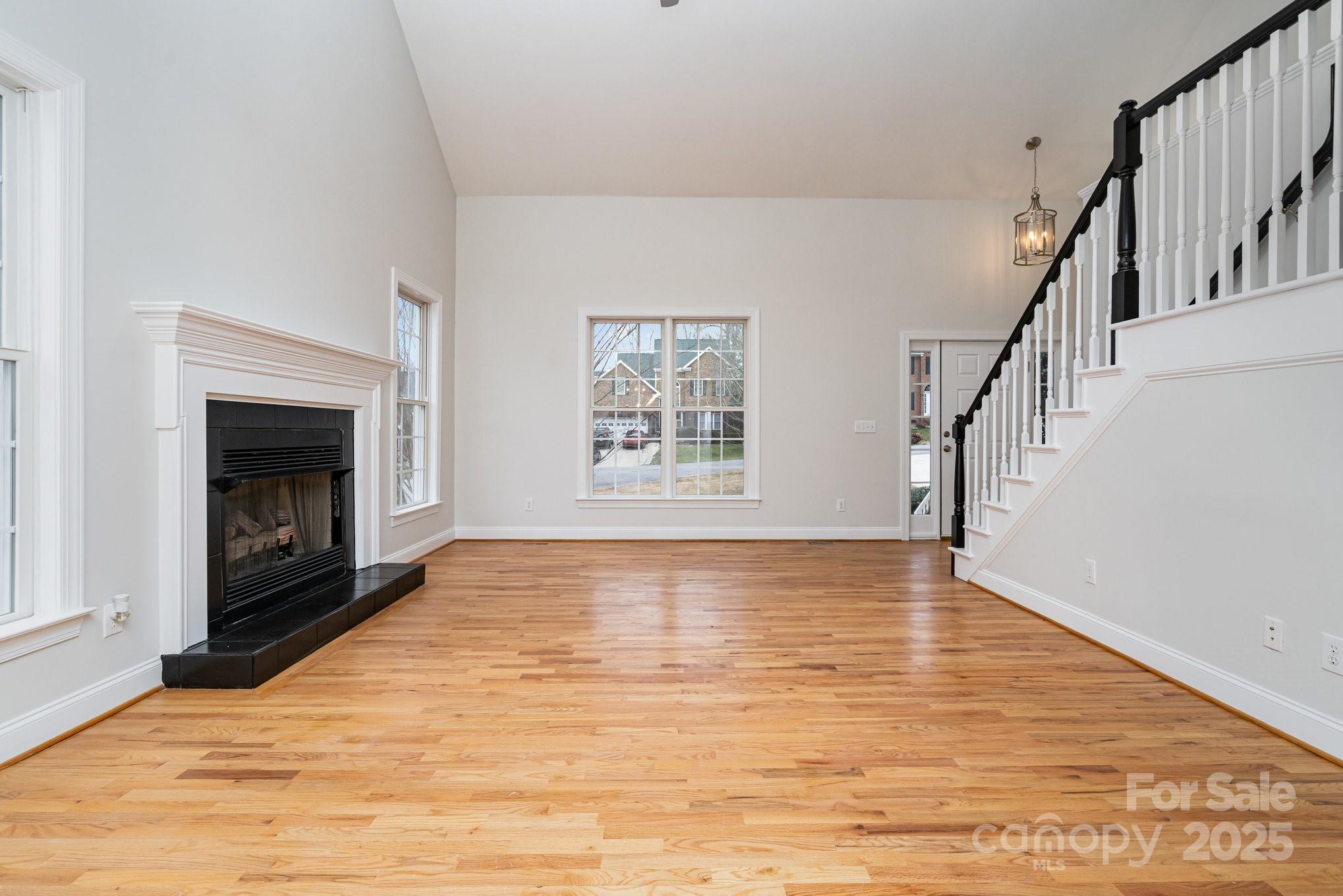 2615 Rolling Ridge Drive Hickory, NC 28602 - Photo 4 of 29 a view of an empty room with wooden floor fireplace and a window