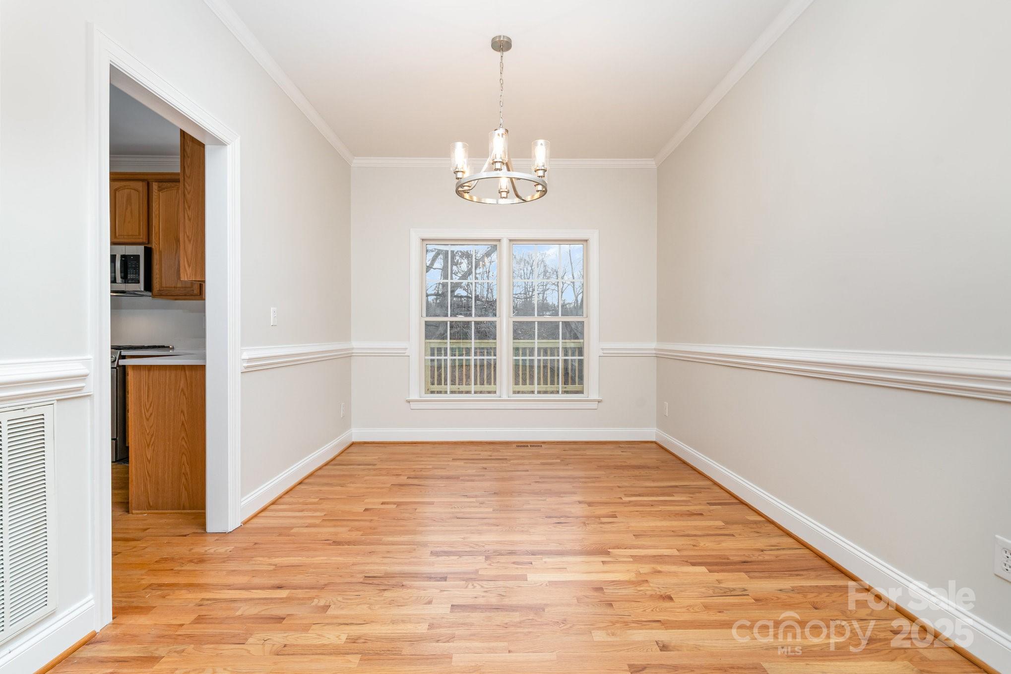 2615 Rolling Ridge Drive Hickory, NC 28602 - Photo 7 of 29 a view of an empty room with wooden floor and a window