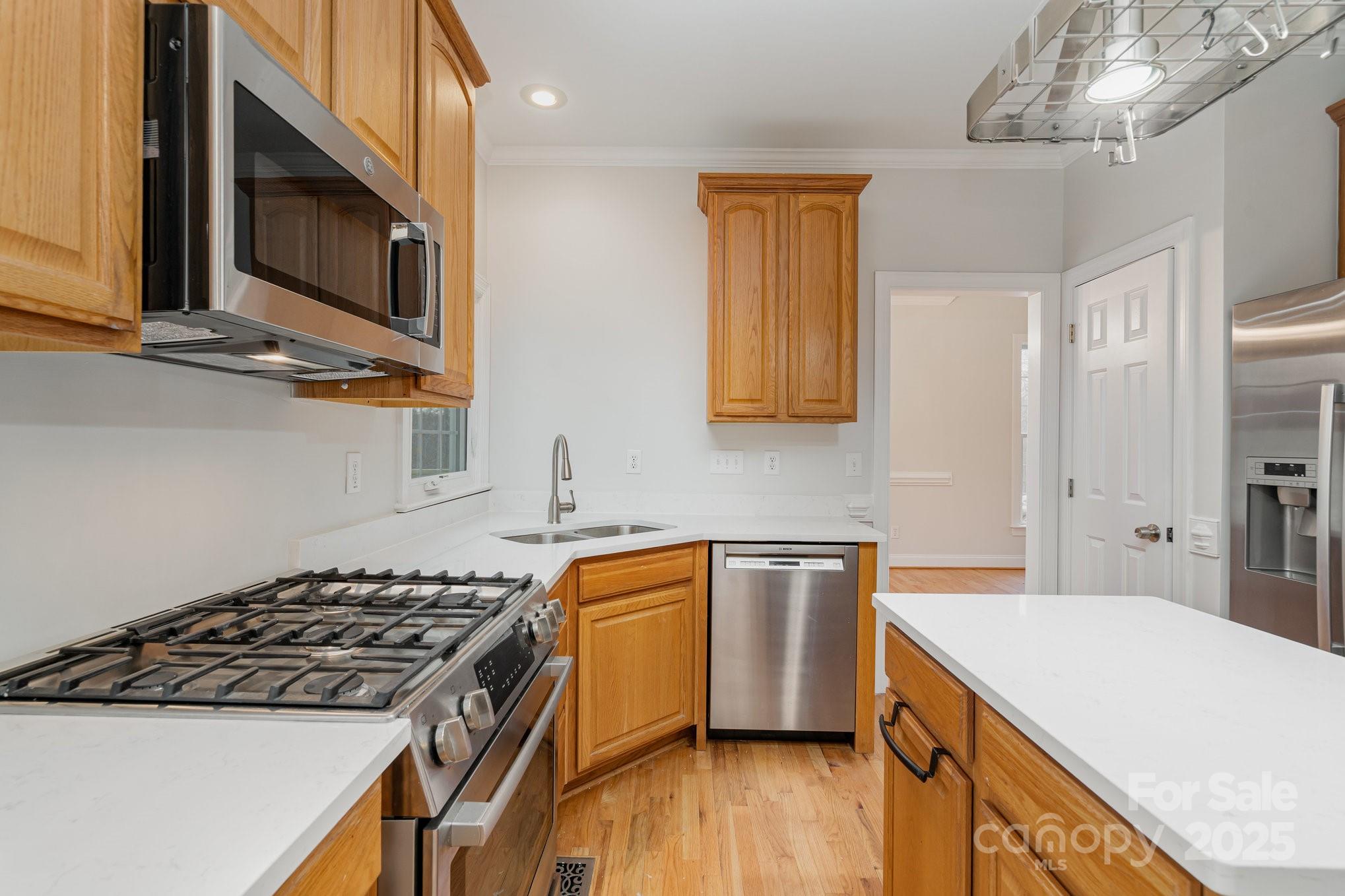 2615 Rolling Ridge Drive Hickory, NC 28602 - Photo 8 of 29 a kitchen with stainless steel appliances a sink a stove top oven a counter space and cabinets