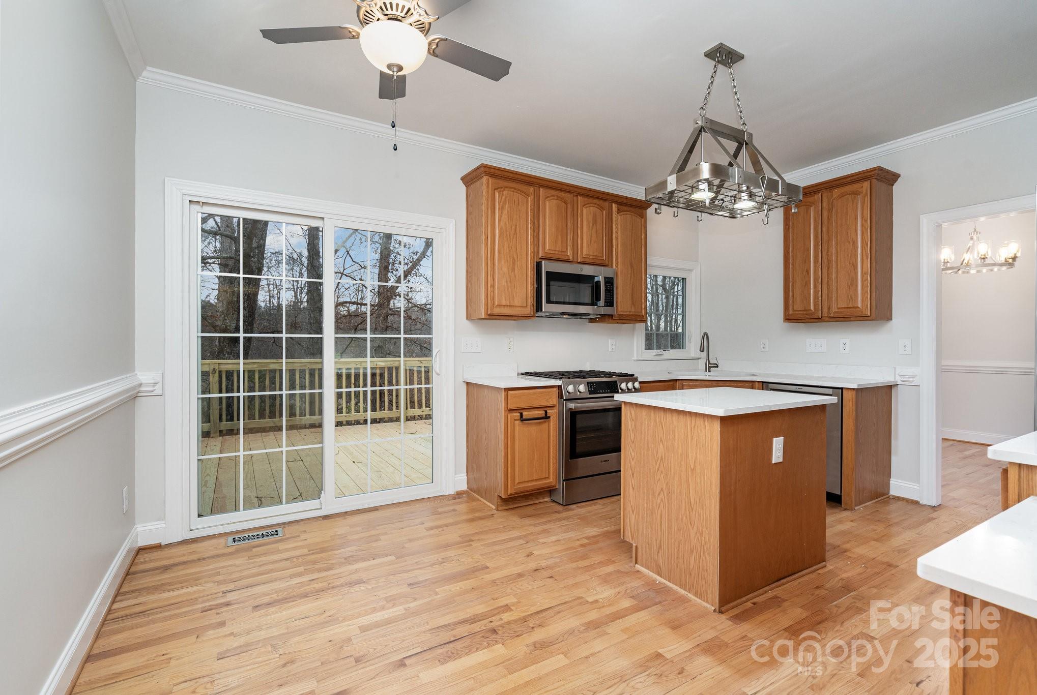 2615 Rolling Ridge Drive Hickory, NC 28602 - Photo 10 of 29 a large kitchen with stainless steel appliances granite countertop a oven stove a sink dishwasher a microwave oven with cabinets and wooden floor