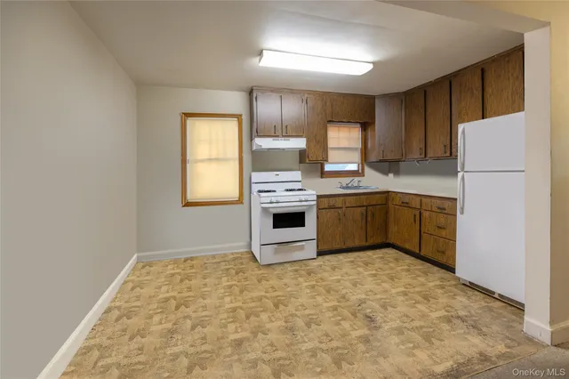 a kitchen with stainless steel appliances granite countertop a refrigerator sink and cabinets