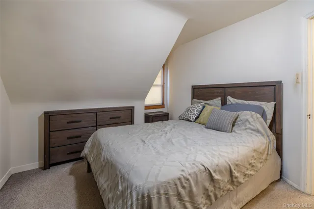 a large bed sitting in a bedroom and dresser