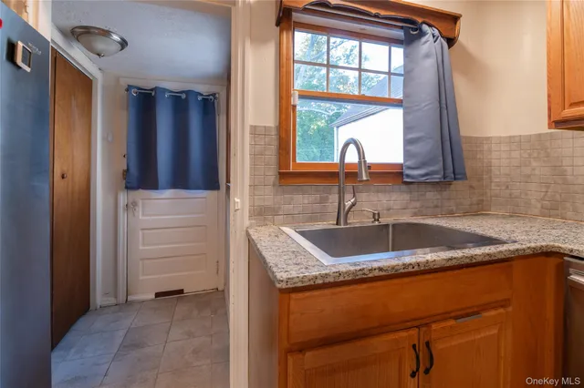 a kitchen with a sink a stove and a refrigerator