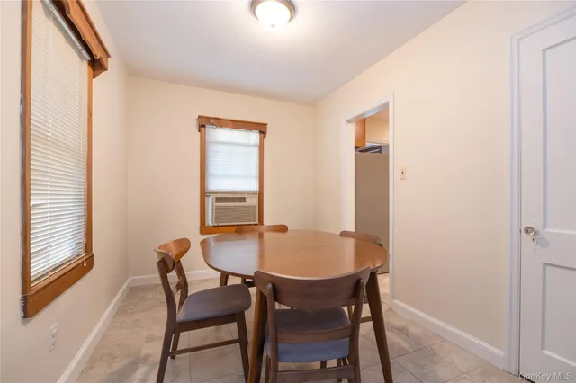 a dining room with furniture and window