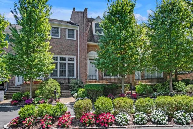 a view of a house with a yard and garden