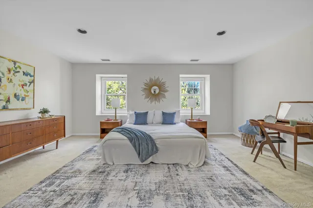 a spacious bedroom with a bed and window