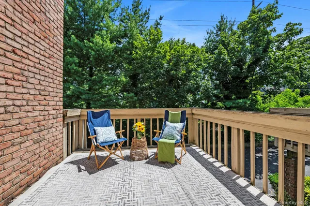 a view of a chairs and table in the balcony