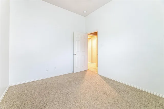 a view of a patio with table and chairs and wooden fence