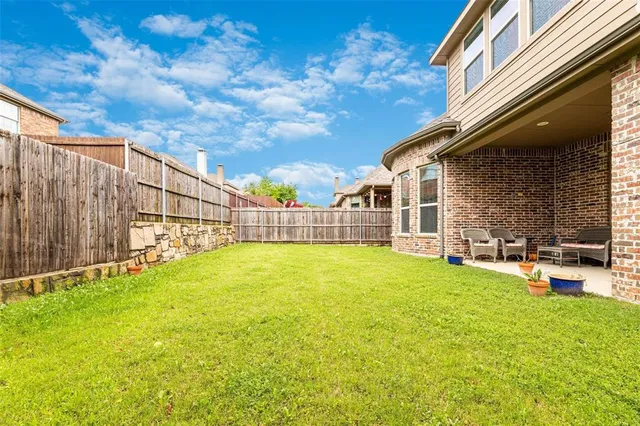 a view of a house with a garden and yard