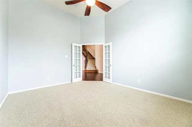 a view of an empty room with a ceiling fan