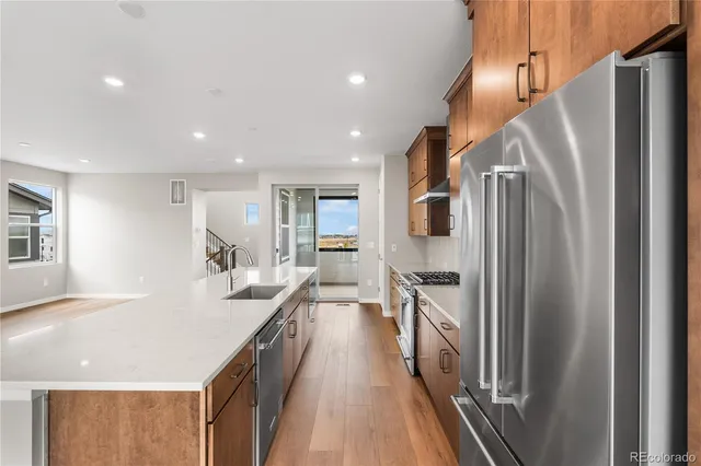 a kitchen with stainless steel appliances a refrigerator and a stove