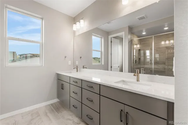 a bathroom with a granite countertop sink mirror and double