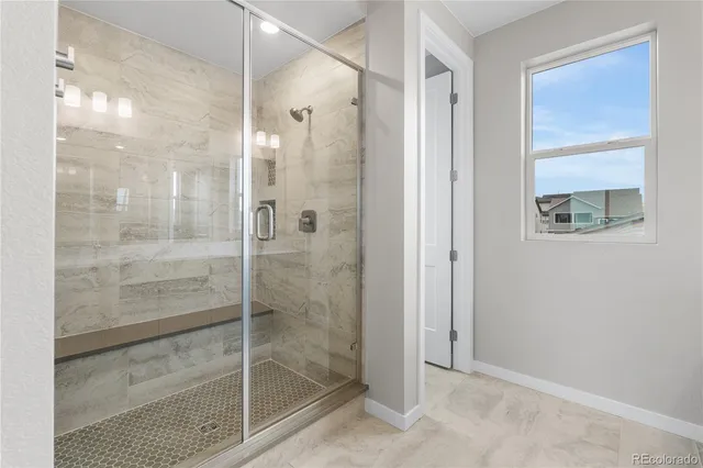 a bathroom with a glass shower door