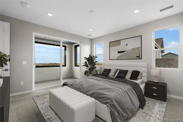 a bedroom with a bed and a couch