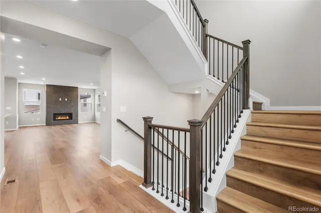 a view of main area with wooden floor and staircase