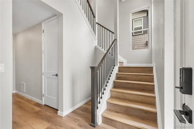a view of entryway and hall with wooden floor