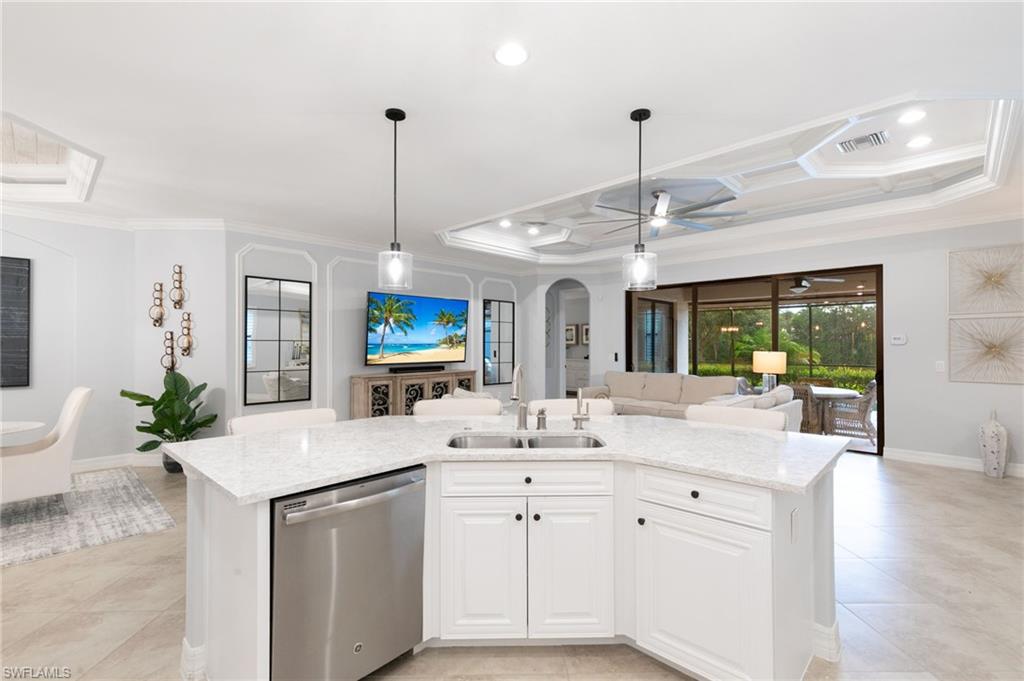 2862 Aviamar Circle Naples, FL 34114 - Photo 48 of 48 Kitchen featuring open floor plan, dishwasher, an island with sink, white cabinetry, and light stone countertops