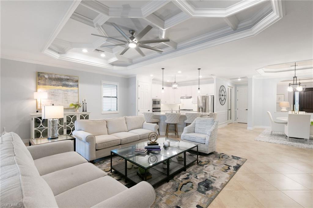 2862 Aviamar Circle Naples, FL 34114 - Photo 15 of 48 Living area featuring ornamental molding, coffered ceiling, a ceiling fan, beam ceiling, and light tile patterned floors