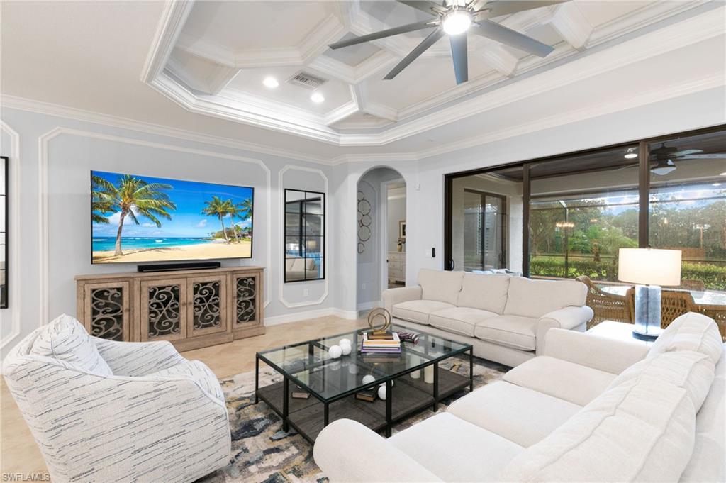 2862 Aviamar Circle Naples, FL 34114 - Photo 16 of 48 Living room with coffered ceiling, beamed ceiling, crown molding, ceiling fan, and arched walkways