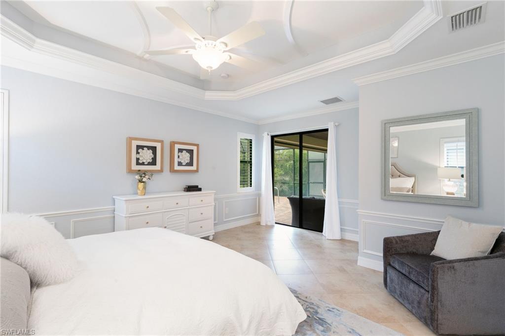 2862 Aviamar Circle Naples, FL 34114 - Photo 19 of 48 Bedroom with access to exterior, a decorative wall, light tile patterned floors, ornamental molding, and ceiling fan